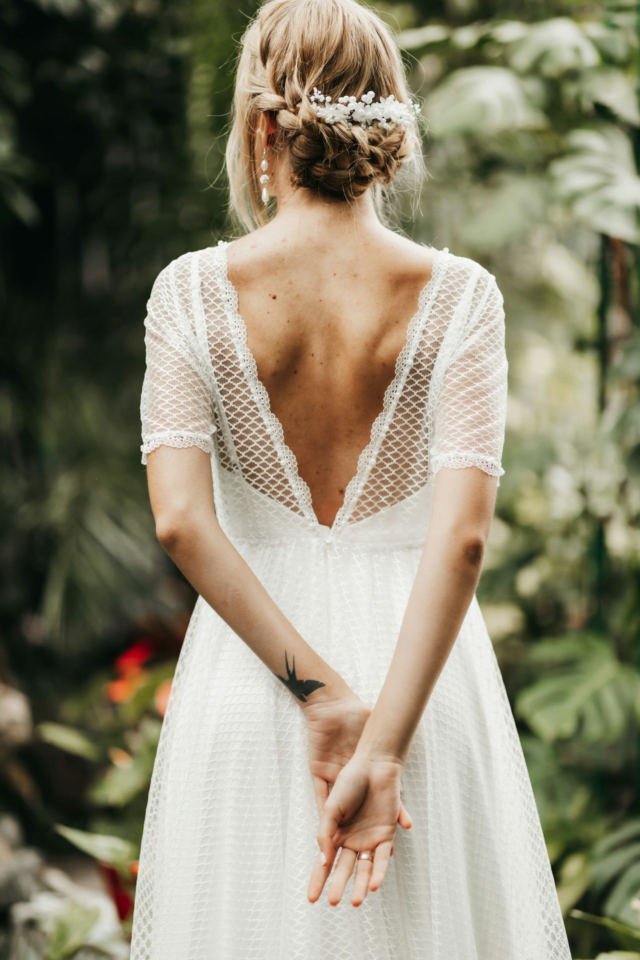 a woman in a white dress holding her hands together